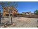 Backyard with block wall, patio, and mature landscaping at 40437 W Robbins Dr, Maricopa, AZ 85138
