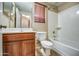 Clean bathroom with neutral tones, a vanity with wood cabinetry, and a shower-tub combo at 40437 W Robbins Dr, Maricopa, AZ 85138