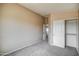 Neutral bedroom with gray carpet, closet and open doorway at 40437 W Robbins Dr, Maricopa, AZ 85138