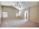 Spacious bedroom features a vaulted ceiling, two windows and an arched doorway to the en-suite bathroom at 40437 W Robbins Dr, Maricopa, AZ 85138