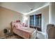 Inviting bedroom with a bed, window, curtains, and a writing desk at 40437 W Robbins Dr, Maricopa, AZ 85138
