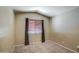 Cozy bedroom with neutral carpet, a window with wood blinds, and ample space at 40437 W Robbins Dr, Maricopa, AZ 85138