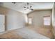 Generous bedroom boasts vaulted ceiling, two windows with blinds, and neutral carpet and walls at 40437 W Robbins Dr, Maricopa, AZ 85138