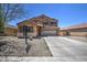 Two-story home featuring a spacious driveway, a two-car garage and neutral-colored exterior at 40437 W Robbins Dr, Maricopa, AZ 85138