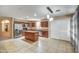 Open-concept kitchen featuring stainless steel appliances, a center island, and tile floors at 40437 W Robbins Dr, Maricopa, AZ 85138