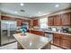 Spacious kitchen features an island, stainless steel appliances, and granite countertops at 40437 W Robbins Dr, Maricopa, AZ 85138