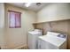 Bright laundry room with newer appliances and shelves at 40437 W Robbins Dr, Maricopa, AZ 85138