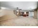 Expansive living room with an eat-in kitchen featuring stainless steel appliances in the background at 40437 W Robbins Dr, Maricopa, AZ 85138