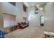A spacious living room featuring soaring ceilings and large windows with wood blinds at 40437 W Robbins Dr, Maricopa, AZ 85138