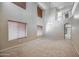 Bright living room featuring high ceilings, neutral carpet, lots of natural light and an open floor plan at 40437 W Robbins Dr, Maricopa, AZ 85138