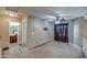 Open loft area with neutral walls, natural light, and carpet floors, ideal for versatile living space at 40437 W Robbins Dr, Maricopa, AZ 85138