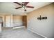 Spacious loft area with a ceiling fan, balcony access, and versatile layout for various needs at 40437 W Robbins Dr, Maricopa, AZ 85138