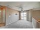 The loft features neutral colors, a ceiling fan, and sliding glass doors to the balcony, offering great views at 40437 W Robbins Dr, Maricopa, AZ 85138