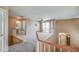 Bright loft features neutral tones, a ceiling fan and sliding glass doors leading to a balcony overlooking the community at 40437 W Robbins Dr, Maricopa, AZ 85138