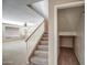 Carpeted staircase with white railing and natural wood handrail, adjoined by a closet at 40437 W Robbins Dr, Maricopa, AZ 85138