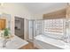 Bright bathroom features a soaking tub, glass-enclosed shower, walk in closet and ample counter space at 4222 E Torrey Pines Ln, Chandler, AZ 85249