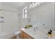 Bright bathroom featuring a shower and tub combination with light wood vanity and a large mirror at 4222 E Torrey Pines Ln, Chandler, AZ 85249