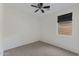 Empty bedroom with carpet flooring, ceiling fan and window at 4222 E Torrey Pines Ln, Chandler, AZ 85249