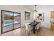 Dining area with a table for six, abstract art and views of the backyard pool through sliding glass doors at 4222 E Torrey Pines Ln, Chandler, AZ 85249