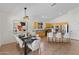 Elegant dining room with modern lighting, and an adjacent kitchen and bar seating at 4222 E Torrey Pines Ln, Chandler, AZ 85249