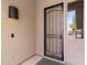 Covered entry with black security door and decorative outdoor wall sconce at 4222 E Torrey Pines Ln, Chandler, AZ 85249