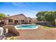 A private backyard features a sparkling in-ground pool, gravel landscape, and a covered patio at 4222 E Torrey Pines Ln, Chandler, AZ 85249