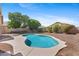 A private backyard features a sparkling in-ground pool, gravel landscape, with mature shade trees at 4222 E Torrey Pines Ln, Chandler, AZ 85249