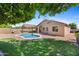 Backyard featuring a private pool, mature landscaping, a covered patio, and a built-in grill at 4222 E Torrey Pines Ln, Chandler, AZ 85249