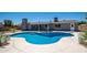 Inviting backyard with a uniquely shaped private pool, spacious deck, and gray exterior home at 4506 W Golden Ln, Glendale, AZ 85302