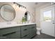 A double vanity featuring sleek modern finishes and round mirrors at 4506 W Golden Ln, Glendale, AZ 85302