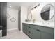 This bathroom features a double sink vanity, modern tile, and decorative mirrors and wall hangings at 4506 W Golden Ln, Glendale, AZ 85302