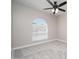 This bedroom features carpet flooring, neutral walls, and a arched window for plenty of natural light at 4506 W Golden Ln, Glendale, AZ 85302