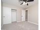 This bedroom features sliding closet doors for plenty of storage and a ceiling fan for comfort at 4506 W Golden Ln, Glendale, AZ 85302