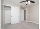 This bedroom features sliding closet doors for plenty of storage and a ceiling fan for comfort at 4506 W Golden Ln, Glendale, AZ 85302
