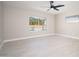 Bright bedroom with a view of the pool through the window, featuring tile flooring and neutral walls at 4506 W Golden Ln, Glendale, AZ 85302