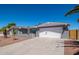 Attractive home featuring a large driveway, desert landscaping, and an attached two-car garage at 4506 W Golden Ln, Glendale, AZ 85302