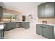 Modern kitchen with olive green cabinets, quartz countertops, stainless steel appliances, and tile backsplash at 4506 W Golden Ln, Glendale, AZ 85302