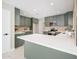 This kitchen features sleek green cabinetry, stainless steel appliances, and a large white countertop at 4506 W Golden Ln, Glendale, AZ 85302
