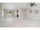 Bright living room featuring neutral paint, tile floors, a ceiling fan, and natural light at 4506 W Golden Ln, Glendale, AZ 85302