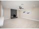 Spacious living room showcasing tile floors, a ceiling fan, and a modern fireplace at 4506 W Golden Ln, Glendale, AZ 85302