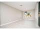 Bright living room featuring neutral paint, tile floors, modern chandelier, and natural light at 4506 W Golden Ln, Glendale, AZ 85302