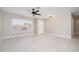 Bright living room featuring neutral paint, tile floors, a ceiling fan, and natural light at 4506 W Golden Ln, Glendale, AZ 85302