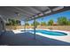 Covered patio overlooks this backyard pool and lush desert landscaping at 4506 W Golden Ln, Glendale, AZ 85302