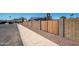View of the block wall and wooden gate that surrounds the property, street, and walkway at 4506 W Golden Ln, Glendale, AZ 85302