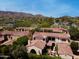 Stunning aerial view of a home with a clay tile roof, lush landscaping, and mountain views in a beautiful neighborhood at 4949 E Lincoln Dr # 11, Paradise Valley, AZ 85253