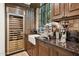 Butler's pantry featuring a beverage cooler, sink, and plenty of cabinet space for entertaining at 4949 E Lincoln Dr # 11, Paradise Valley, AZ 85253