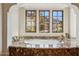 Marble soaking tub with views of the mountains and desert framed by three windows at 4949 E Lincoln Dr # 11, Paradise Valley, AZ 85253