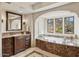 The bathroom features a large soaking tub with marble accents and vanity with granite countertops at 4949 E Lincoln Dr # 11, Paradise Valley, AZ 85253