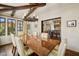 Charming dining area boasts wood beams, a statement chandelier, and open access to the living room and kitchen at 4949 E Lincoln Dr # 11, Paradise Valley, AZ 85253
