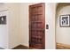 Elevator with a wood door in a naturally lit hallway at 4949 E Lincoln Dr # 11, Paradise Valley, AZ 85253